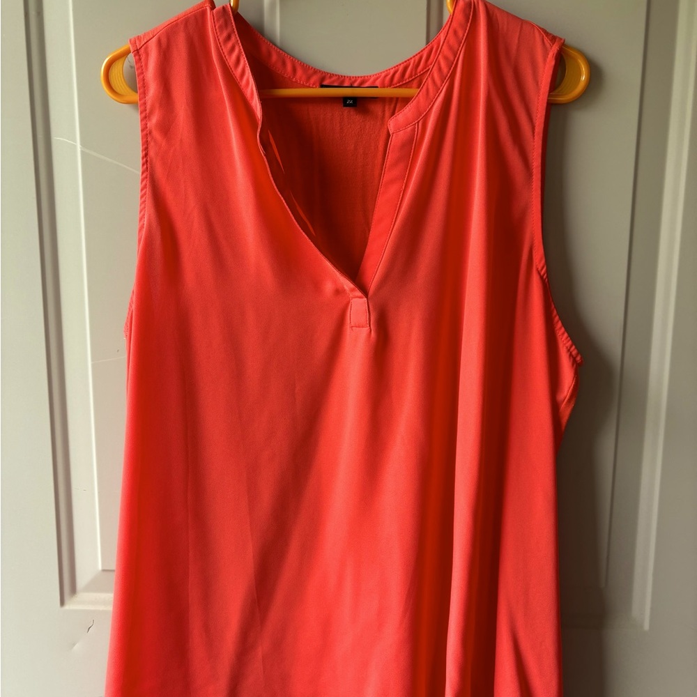 Sleeveless tunic blouse in orange/coral.
